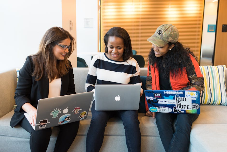 Three women working together on laptops